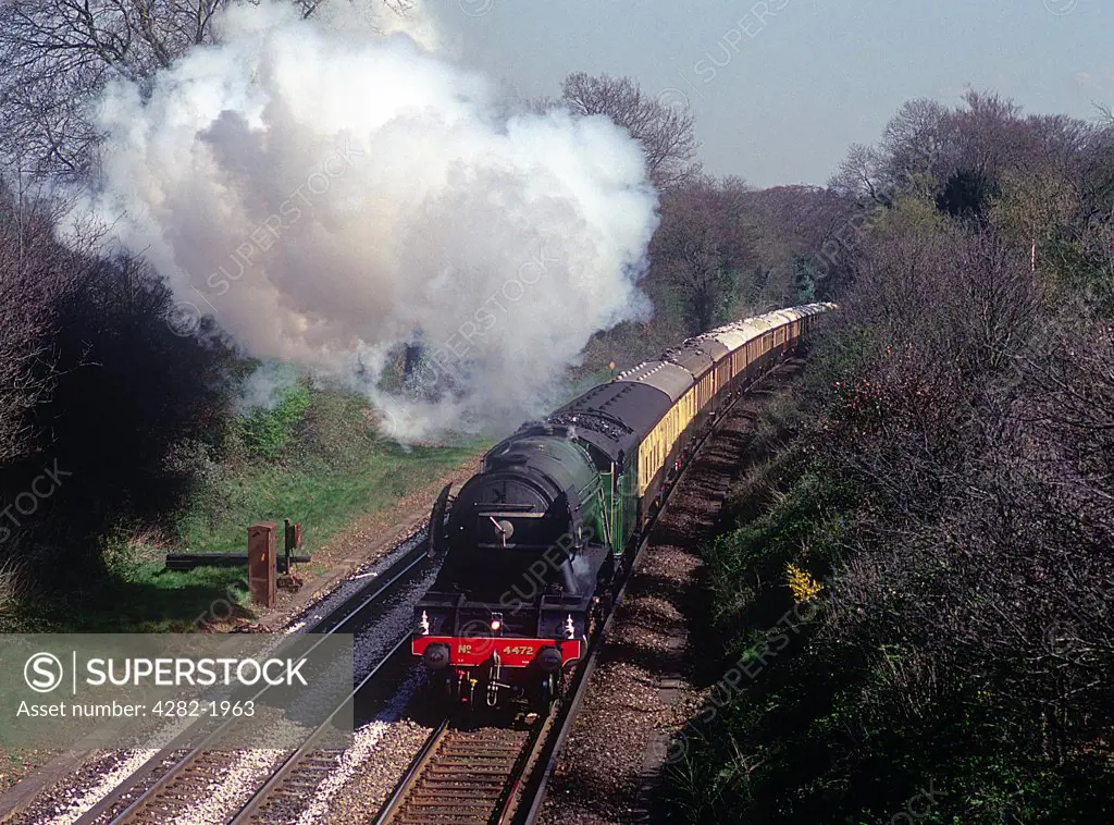 England, West Sussex, Milford. Pacific steam locomotive powering through the countryside near Milford.