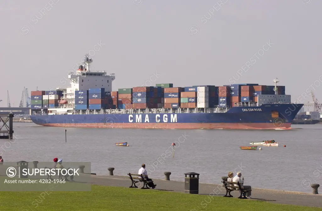England, Kent, Gravesend. Container ship sailing down the Thames Estuary near Gravesend.