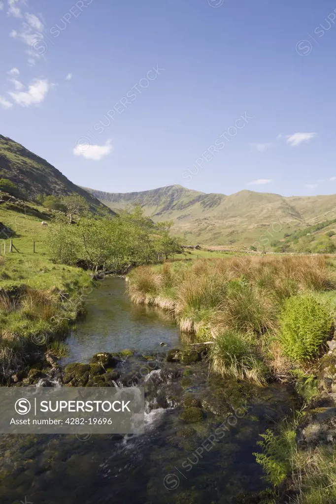 North Wales, Gwynedd, Cwm Pennant. Afon Dwyfor river and single track country lane in a rural Welsh valley in the Snowdonia National Park.