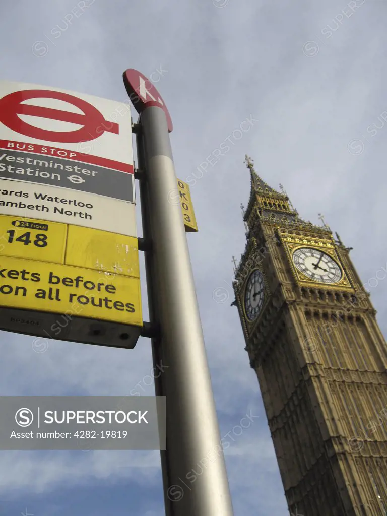 England, London, Westminster. Big Ben behind a bus stop sign in Westminster.