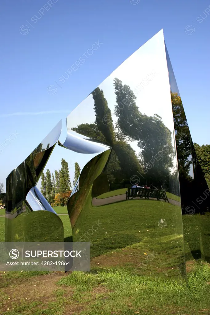 England, London, Regents Park. A reflective metal pyramid in Regents Park in London.