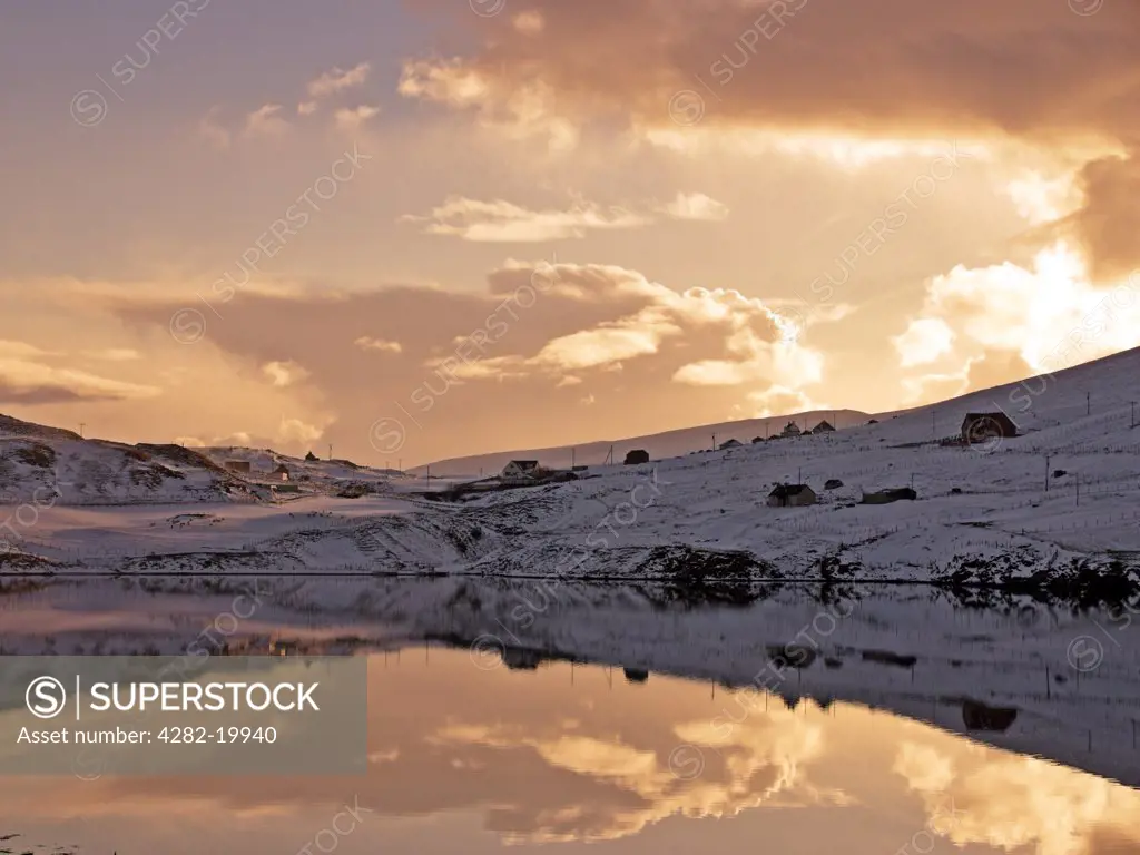 Scotland, Shetland, Unst. Snowy sunset at Voe on Shetland.