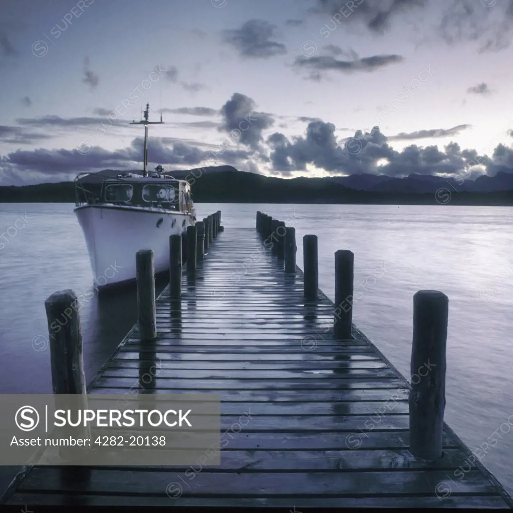 England, Cumbria, Lake Windemere. A pier at dusk on Lake Windemere.