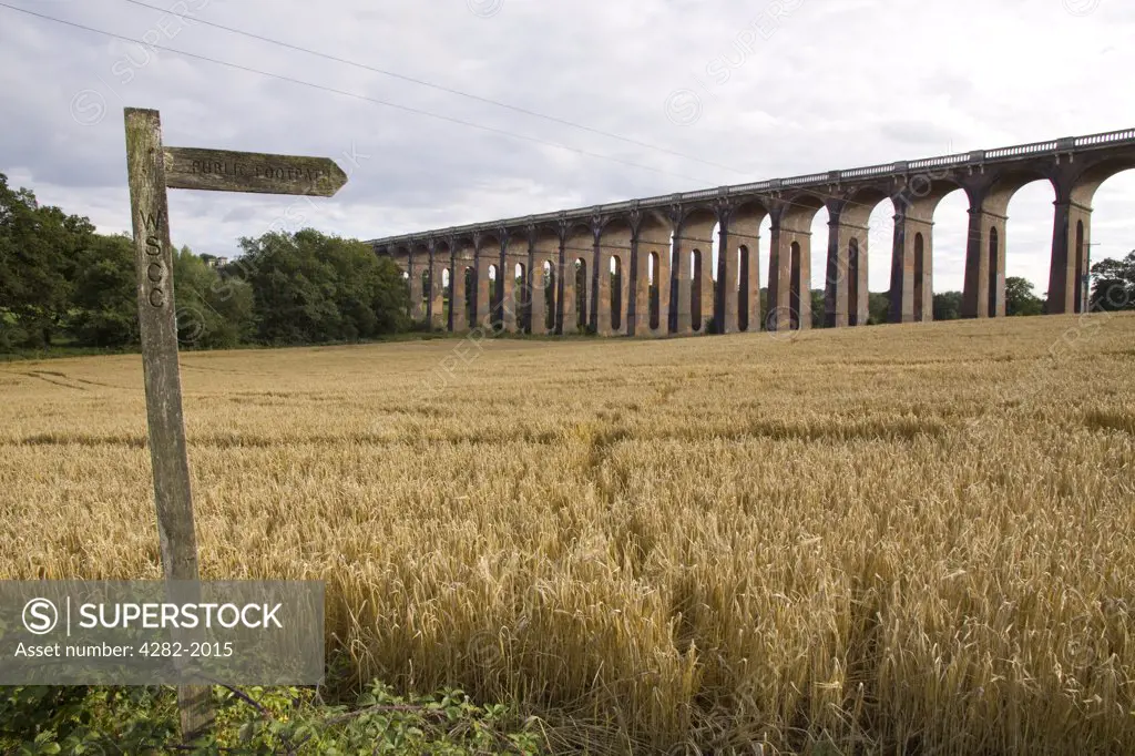 England, West Sussex, Balcombe. Public footpath sign with the Ouse Valley Viaduct in the background.