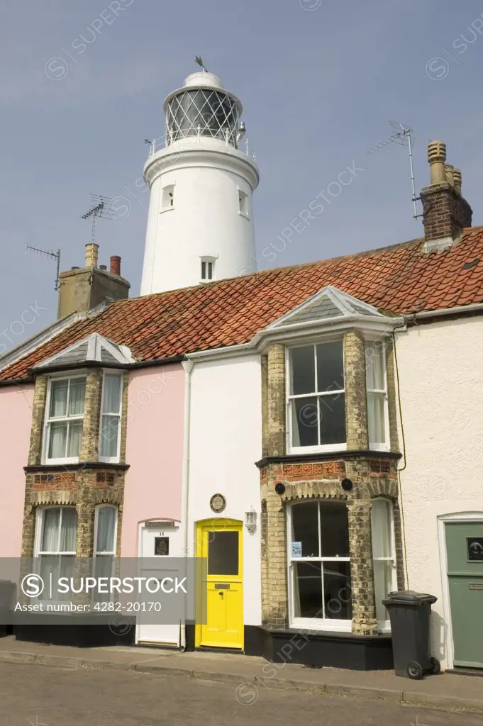 England, Suffolk, Southwold. Houses and Southwold Lighthouse. The Lighthouse station was electrified and automated in 1938.