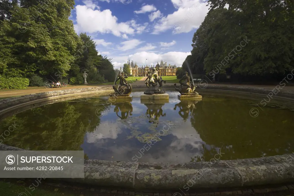 England, Buckinghamshire, near Aylesbury. Clouds and Statues reflected in the fountain of Waddeston Manor built for Baron Ferdinand de Rothschild and designed by Gabriel-Hippolyte Destailleur.