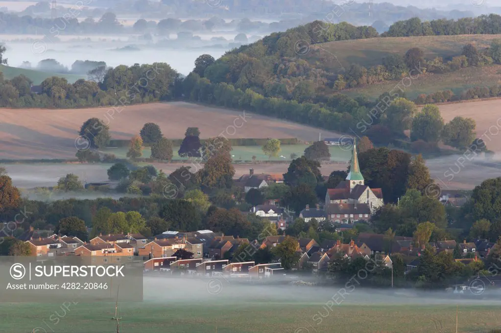 England, West Sussex, South Harting. Dawn mist surrounding the Village of South Harting on the South Downs.