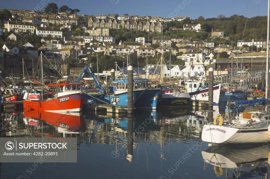 England, Cornwall, Newlyn. Reflections of fishing boats in the Cornish fishing town of Newlyn.