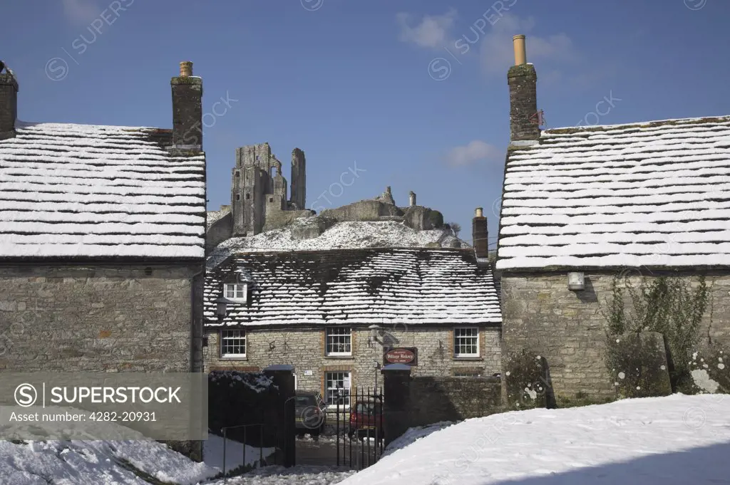 England, Dorset, Corfe Castle. Corfe Castle and village in winter snow.
