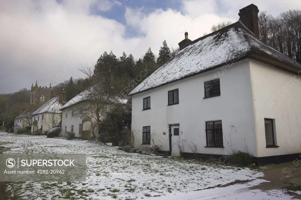 England, Dorset, Milton Abbas. Snow on the thatched rooftops of houses in the village of Milton Abbas. The village is sometimes considered the first planned settlement in England.