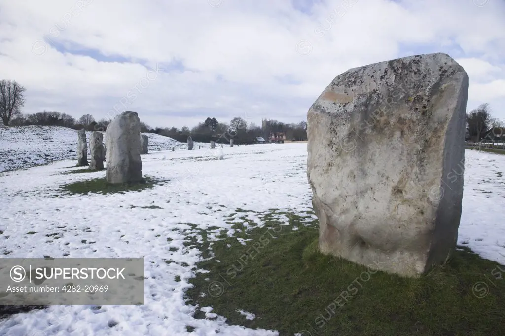 England, Wiltshire, Avebury. Avebury with snow on the ground on a winter morning. Avebury is the largest stone circle in the world, it is 427m in diameter and covers an area of 28 acres.