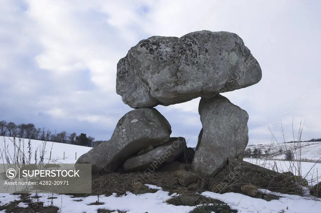 England, Wiltshire, Marlborough. Devil's Den in winter snow, a Dolmen/ Quoit/ Cromlech nr Marlborough in Wiltshire. The three stones are all that remains of a more extensive chambered tomb.