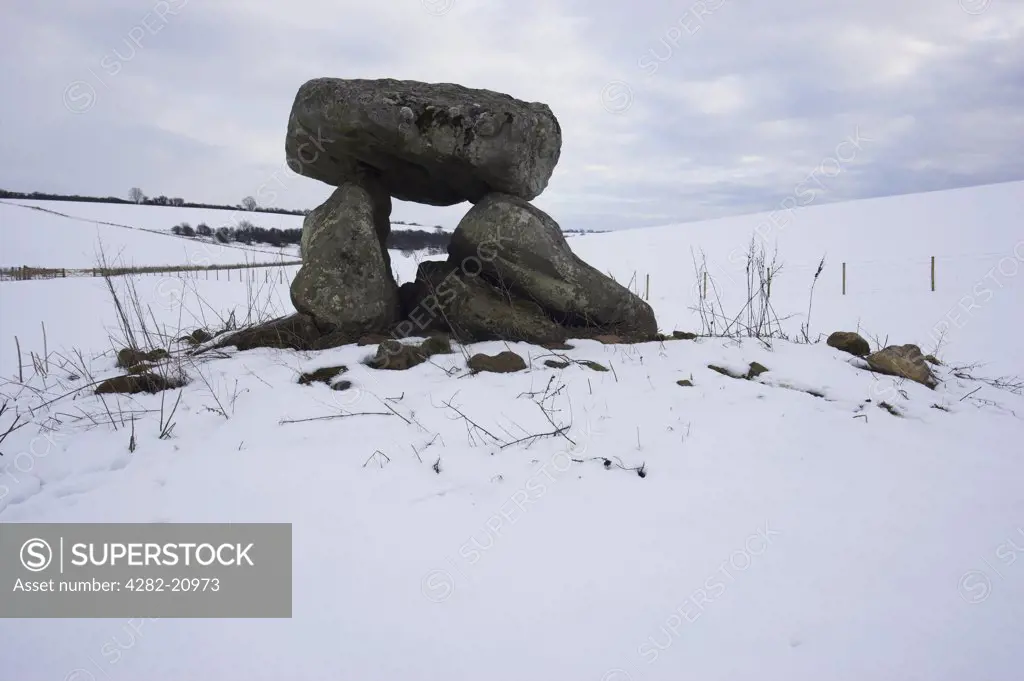 England, Wiltshire, Marlborough. Devil's Den in winter snow, a Dolmen/ Quoit/ Cromlech nr Marlborough in Wiltshire. The three stones are all that remains of a more extensive chambered tomb.