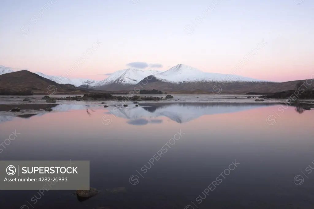 Scotland, Argyll and Bute, Rannoch Moor. Black Mount reflected in Loch Tulla on Rannoch Moor in early dawn light.