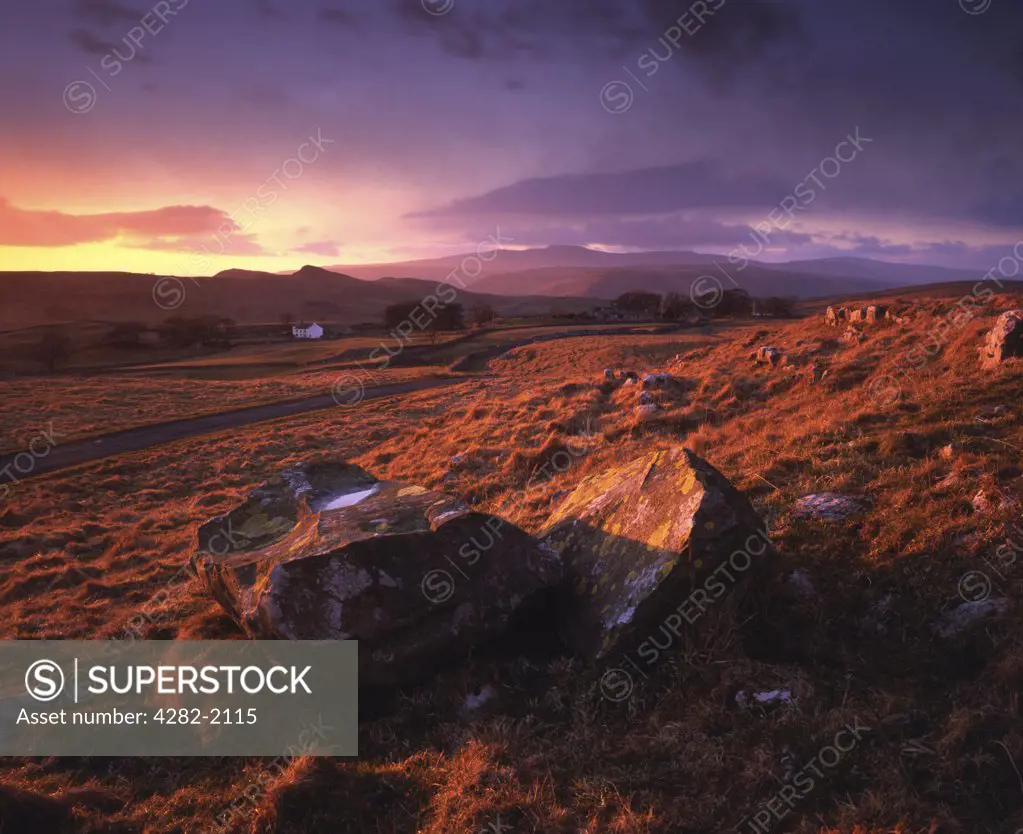 England, North Yorkshire, Winskill. The view towards Winskill Farm from Winskill Stones near Settle in the Yorkshire Dales National Park.  Smeasett Scar, Ingleborough and Moughton can be seen in the distance.