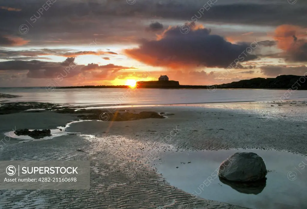 Sunset over St Cwyfans church also known as the Church of the Sea at Aberffraw on Anglesey.