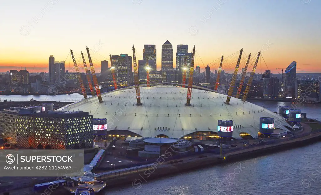 A view from the Emirates Airline of the 02 Arena at sunset with Canary Wharf and the London skyline in the background.
