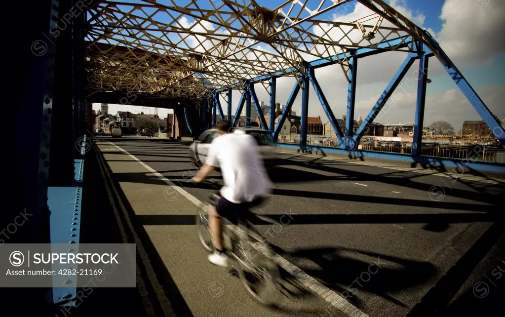 England, East Yorkshire, Kingston Upon Hull. A cyclist crossing the Drypool Bridge in Kingston Upon Hull.