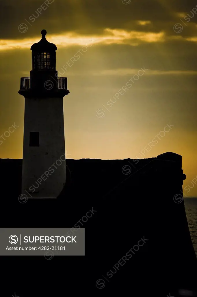 England, Cumbria, Whitehaven. A silhouette of the lighthouse at sunset in Whitehaven.