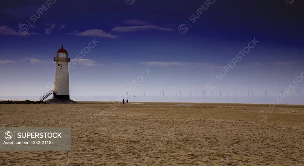 Wales, Denbighshire, Talacre. A view from the beach at low tide to Talacre Lighthouse.