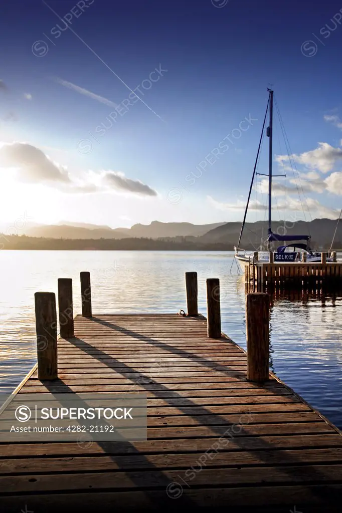 England, Cumbria, Windemere. A view from a wooden jetty out to Lake Windemere.