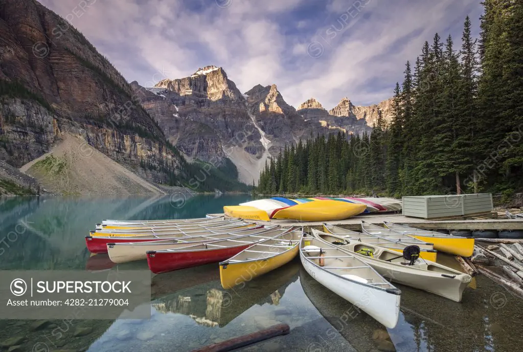 Multicoloured canoes on Moraine Lake in the valley of the ten peaks.