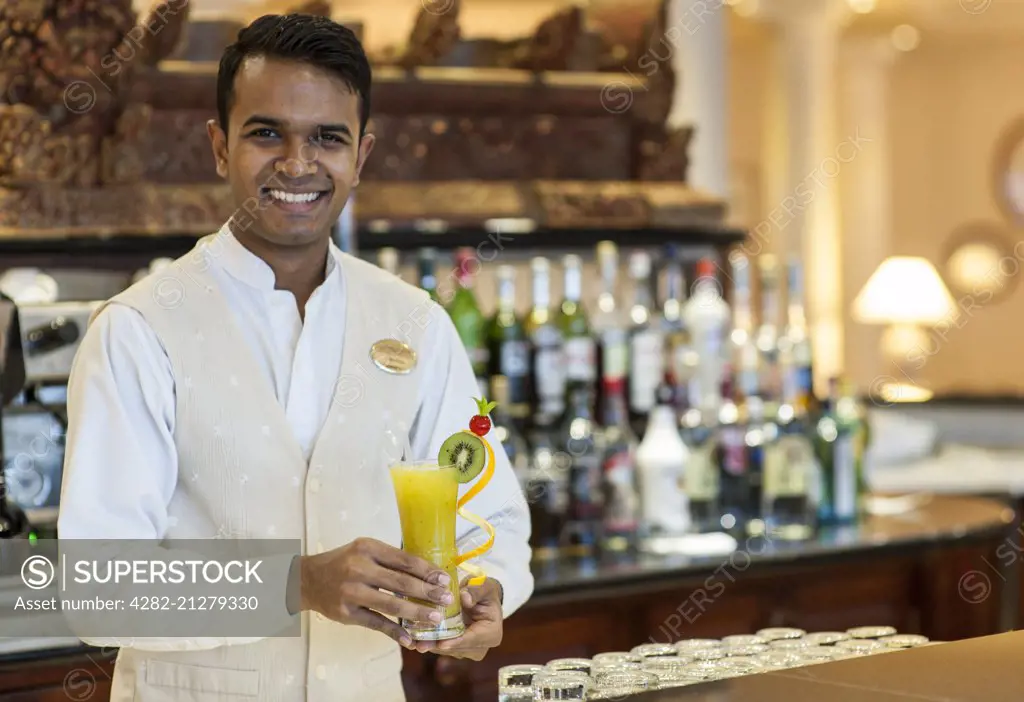 Bartender with cocktail at the Residence hotel in Mauritius.
