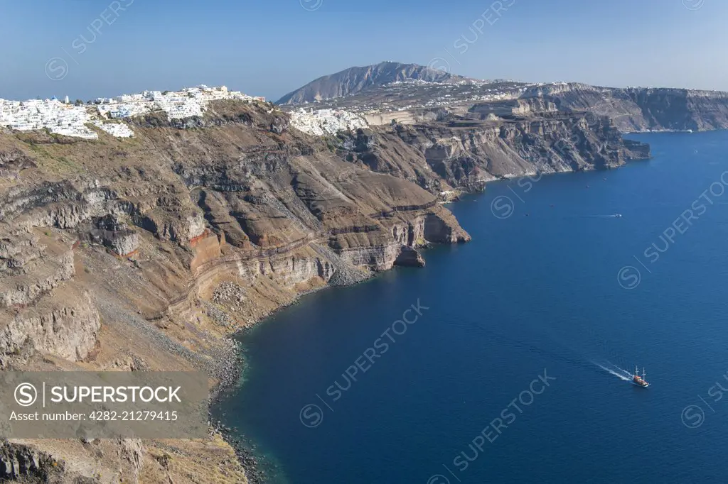 View of the coastline and houses of Fira and Firostefani on the Greek island of Santorini.