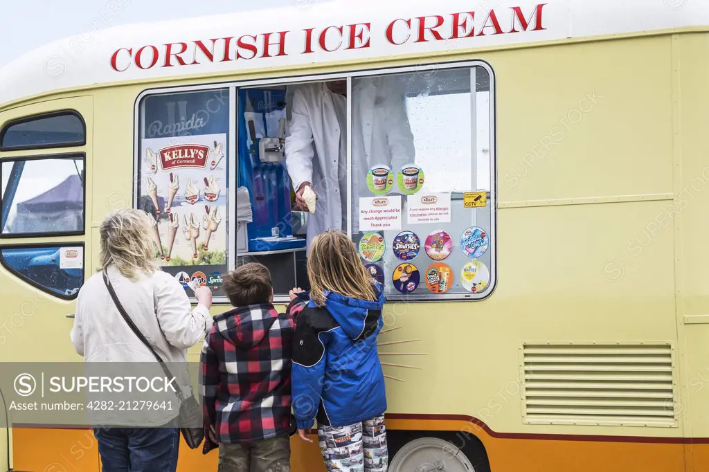Children being served ice cream from an ice cream van.