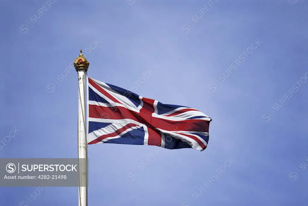 England, London, Buckingham Palace. The Union Jack flag flying over Buckingham Palace.