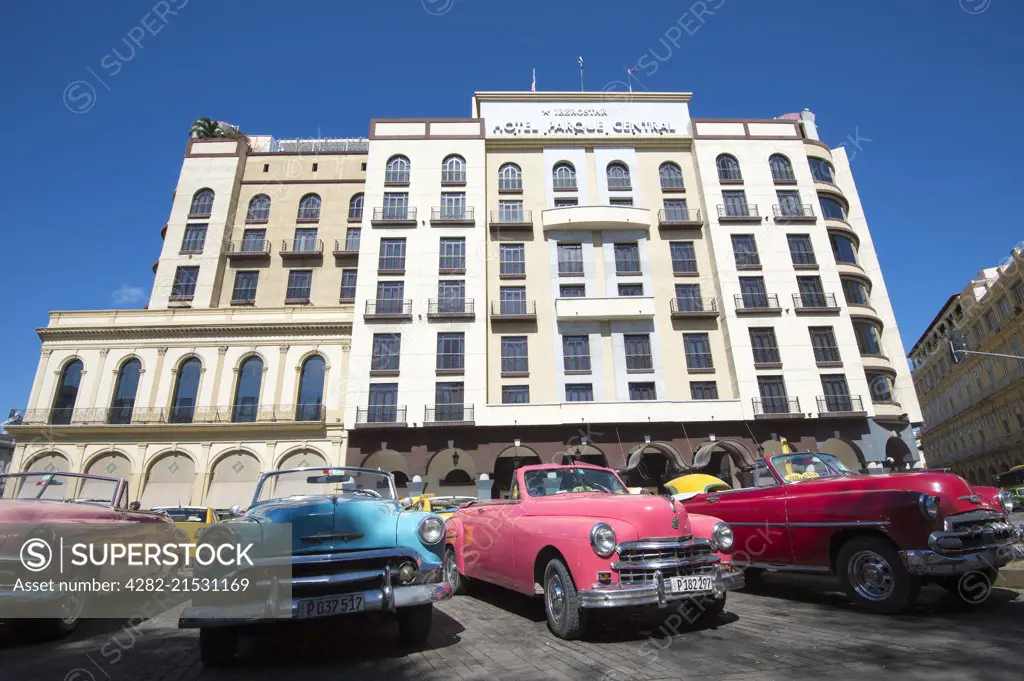 The Hotel Parque Central with American cars outside.