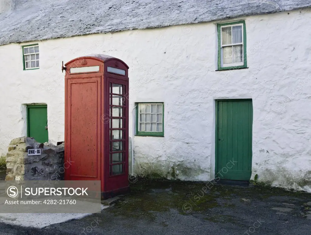 Wales, Anglesey, Maenaddwyn. A public telephone box outside a remote farmhouse, previously a sub post office in Maenaddwyn.