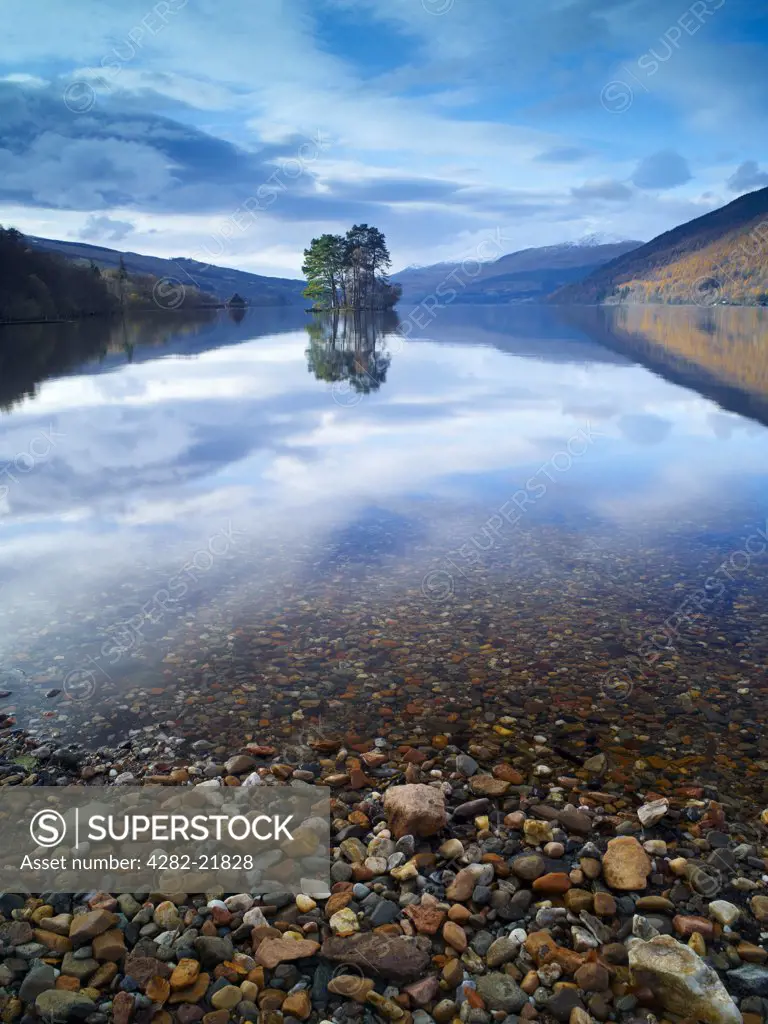 Scotland, Perth and Kinross, Rannoch Moor. The sky and surrounding hillside reflected in the still waters of Loch Tay on a winter morning.