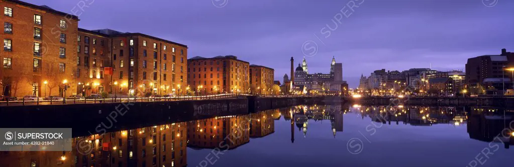 England, Merseyside, Liverpool. View across the Albert Dock towards the Liver Building as twilight descends.