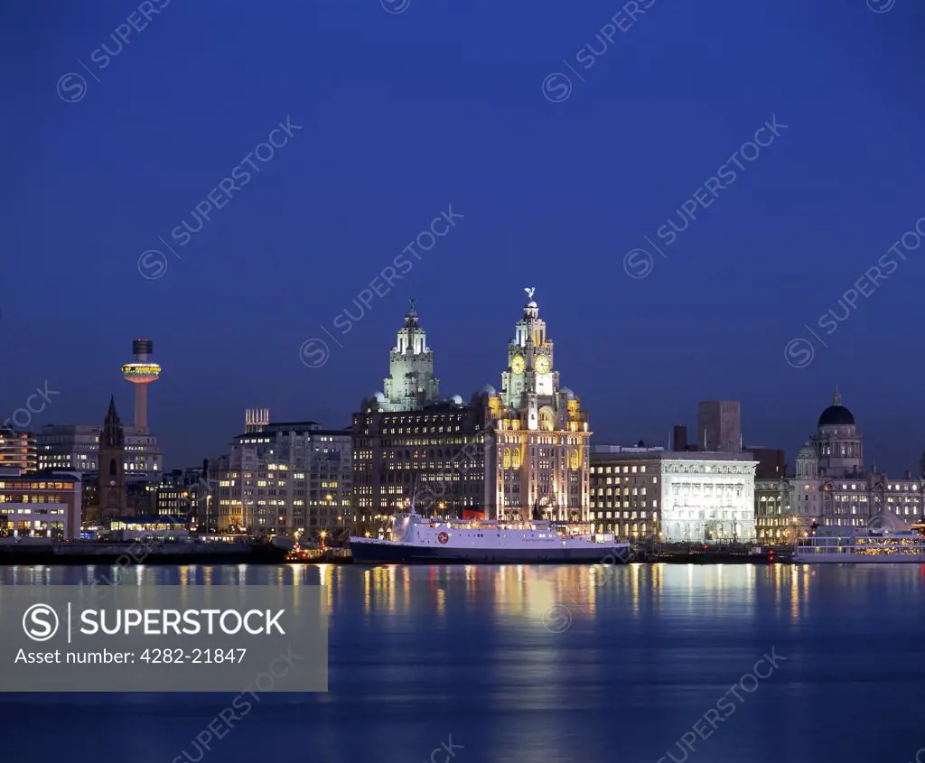 England, Merseyside, Liverpool. View across the River Mersey of the famous Liverpool waterfront at night.
