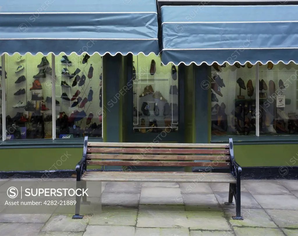 England, East Riding of Yorkshire, Bridlington. A bench outside a traditional shoe shop in the old part of Bridlington.
