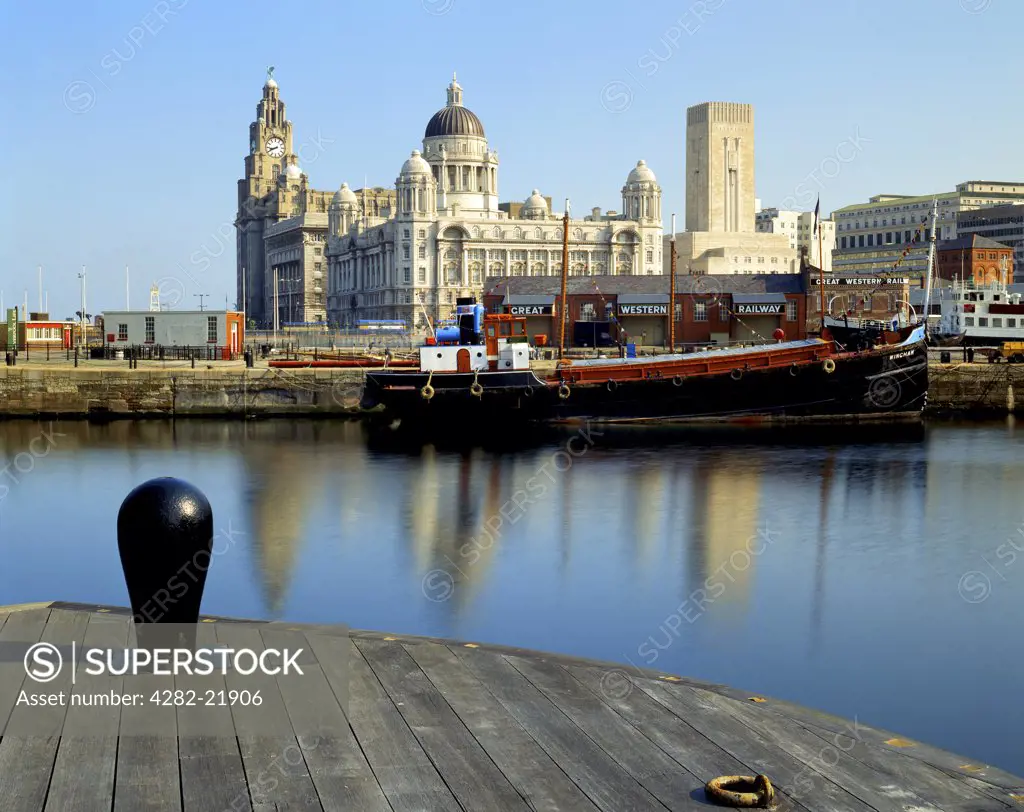 England, Merseyside, Liverpool. View towards the Port of Liverpool Building, the Cunard Building and the Royal Liver Building, Liverpool's Three Graces, from the Albert Dock on the Liverpool waterfront.