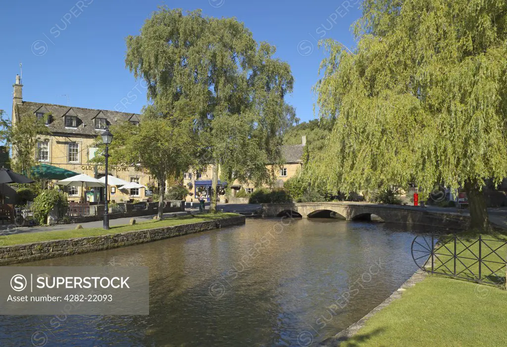 England, Gloucestershire, Bourton-on-the-Water. Looking across the River Windrush to the Old Manse Hotel in Bourton on the Water.