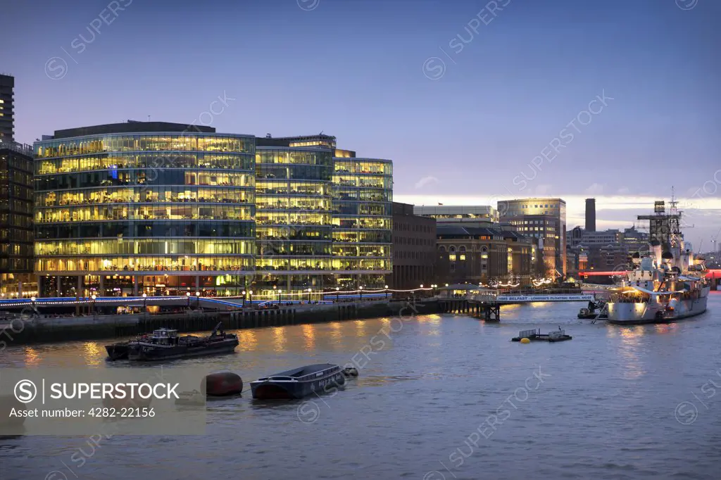 England, London, South Bank. The south bank of the River Thames viewed from Tower Bridge at dusk.