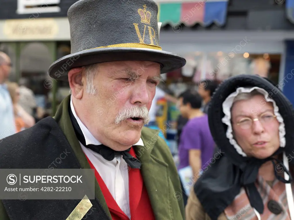 England, Kent, Rochester. A man and woman dressed in Victorian clothing at the Dickens Festival in Rochester.