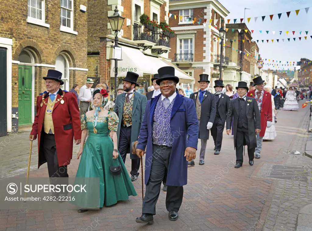 England, Kent, Rochester. People dressed in Victorian costumes parading in the streets of Rochester at the Dickens Festival 2010.
