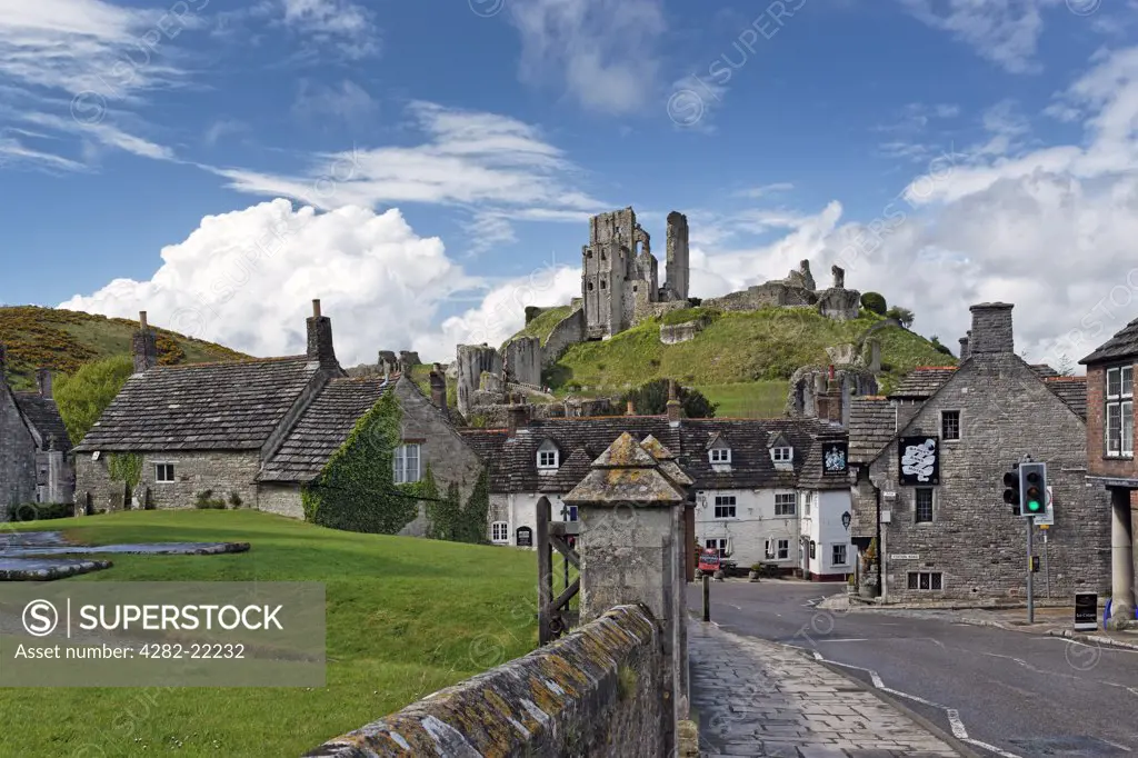 England, Dorset, Wareham. Corfe Castle commanding a gap in the Purbeck Hills overlooking the Bankes Arms Hotel.