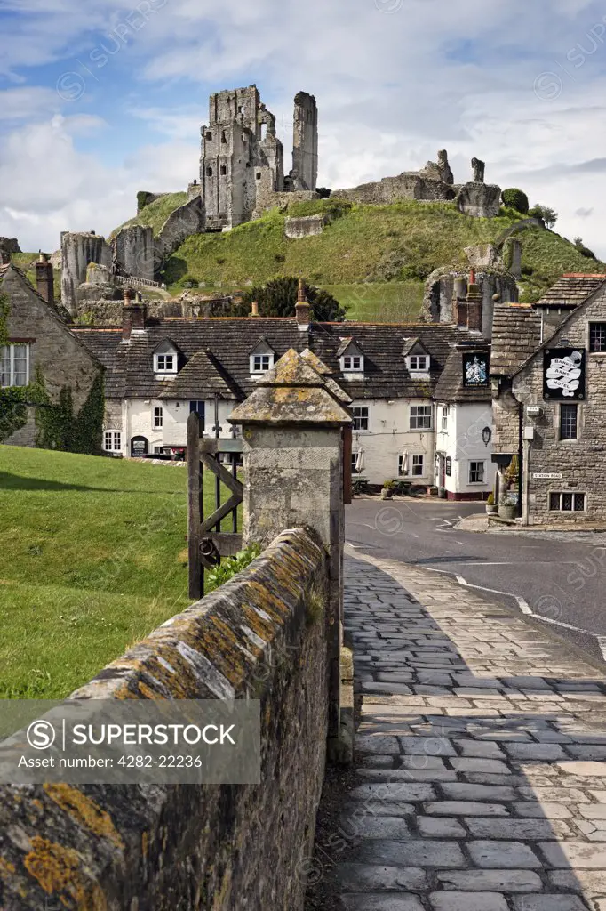 England, Dorset, Corfe Castle. Corfe Castle overlooking the Bankes Arms Hotel in the village below.