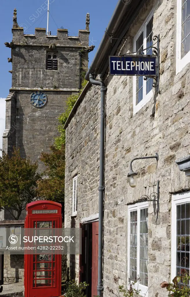 England, Dorset, Corfe Castle. Old telephone sign and box in Corfe Castle.