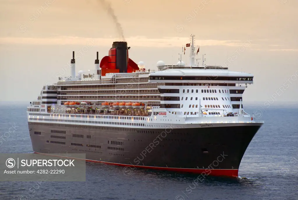 Monaco. RMS Queen Mary 2, the largest ocean liner ever built, off the port of Monaco at dusk.
