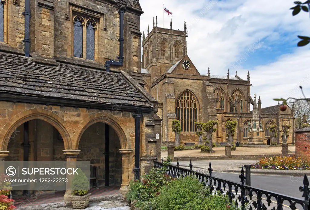 England, Dorset, Sherborne. Abbey Church of St Mary the Virgin at Sherborne in Dorset, usually called Sherborne Abbey. The Almshouse of St John is in the left foreground.