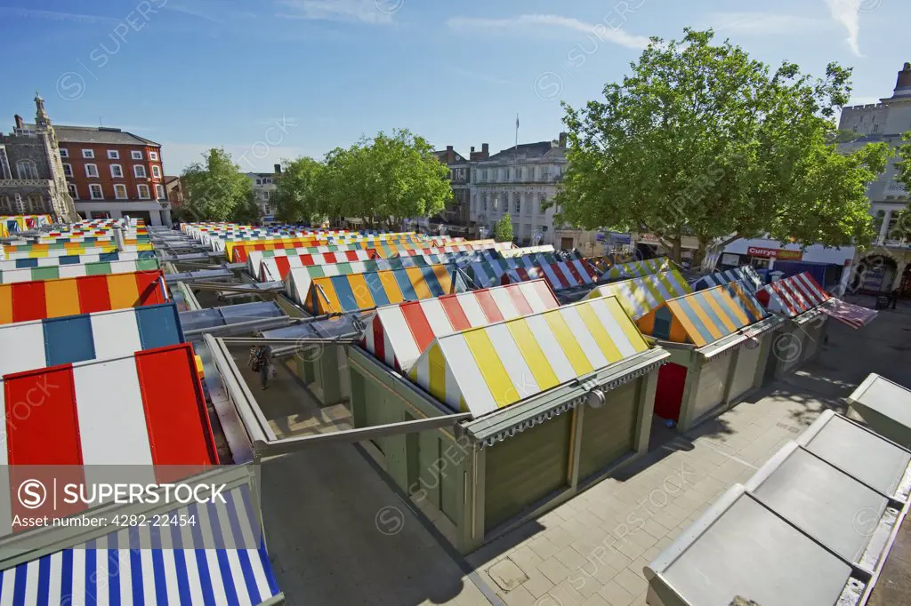 England, Norfolk, Norwich. The brightly coloured canopies of stalls on Norwich Market.