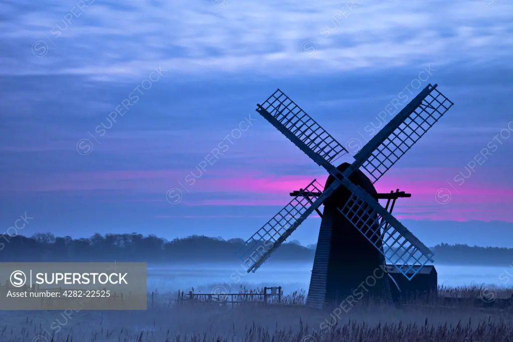 England, Suffolk, Herringfleet. Herringfleet smock mill in the mist on a winter morning.