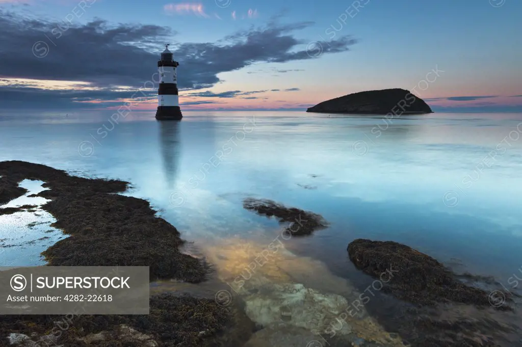 Wales, Anglesey, Penmon. Penmon lighthouse and Puffin Island at Penmon Point on the Isle of Anglesey.