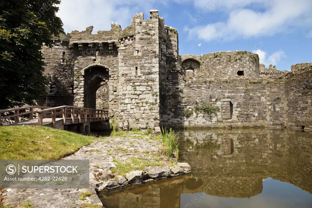 Wales, Anglesey, Beaumaris. The gate next to the sea and water-filled moat of Beaumaris Castle.